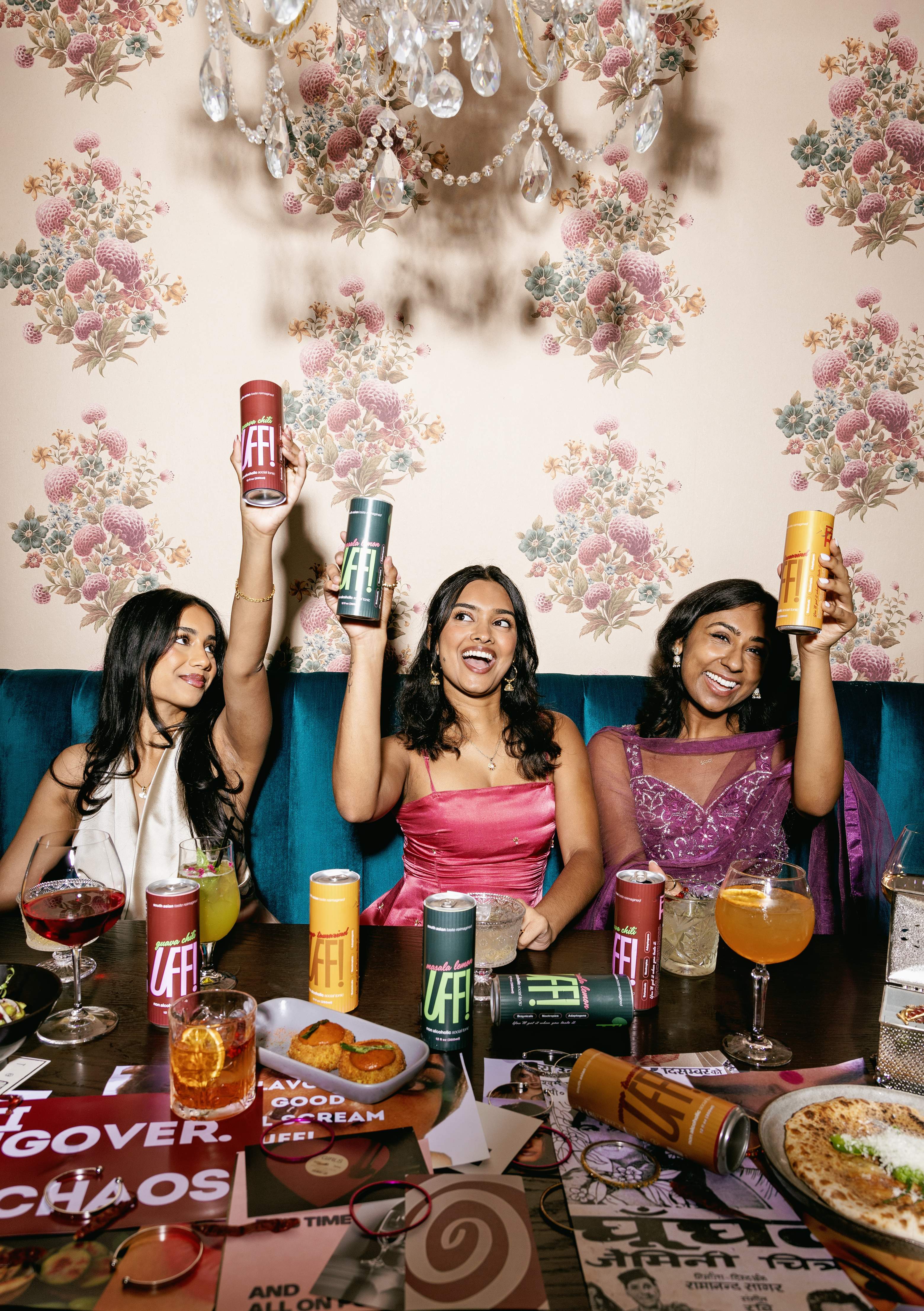 Three friends raising UFF! cans in a toast