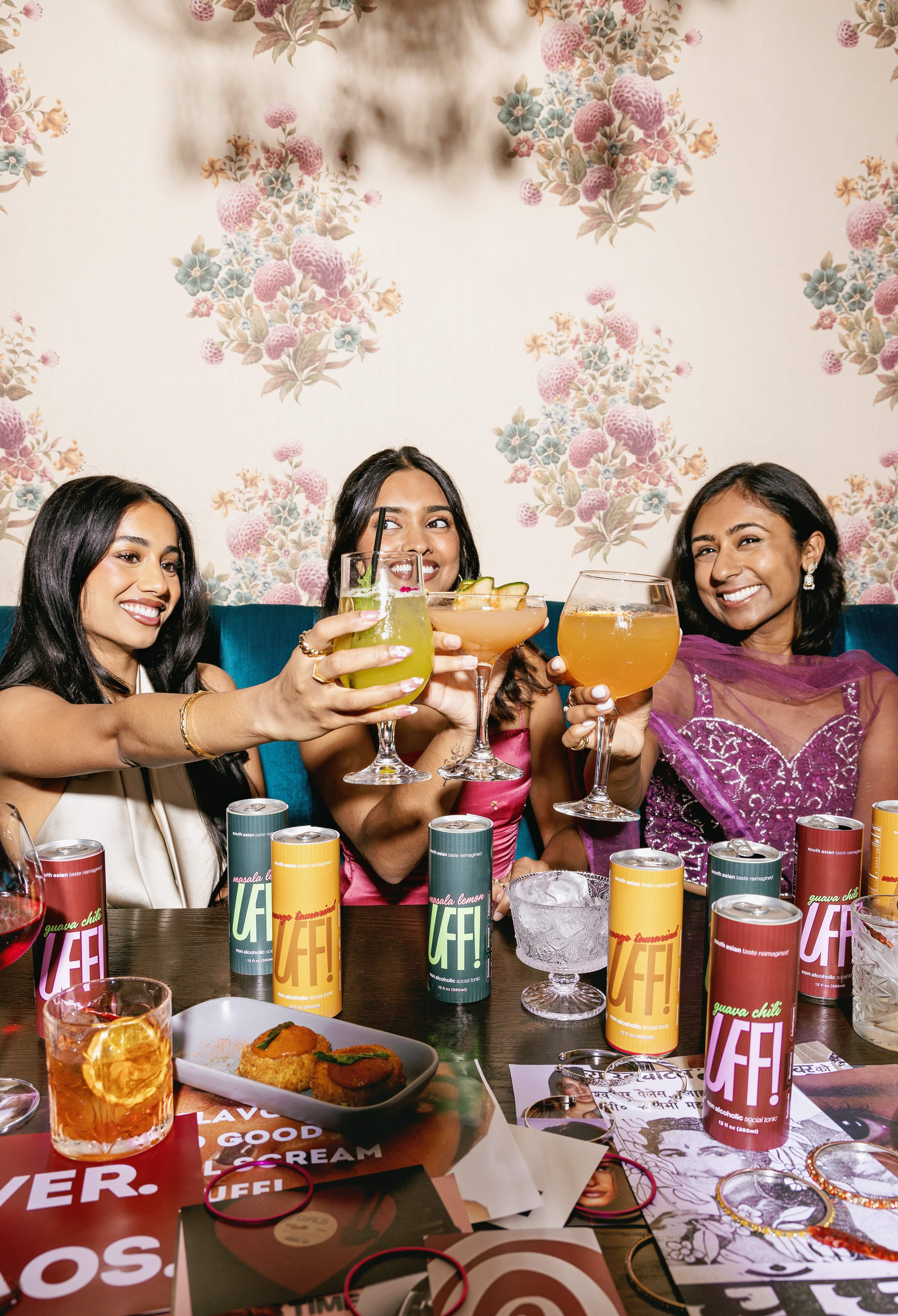 The girls raising a toast across the table