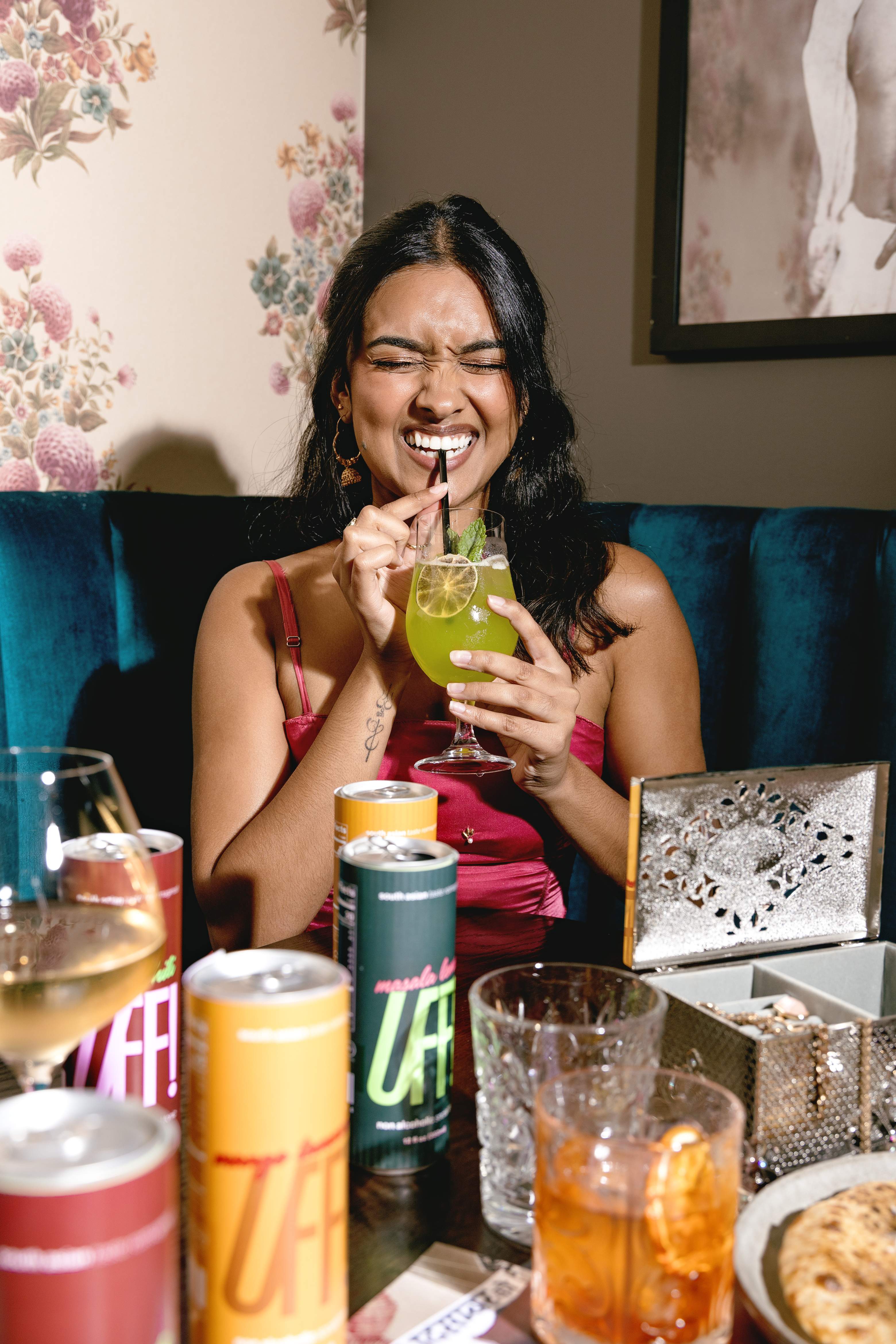 A guest laughing over a masala lemon spritz