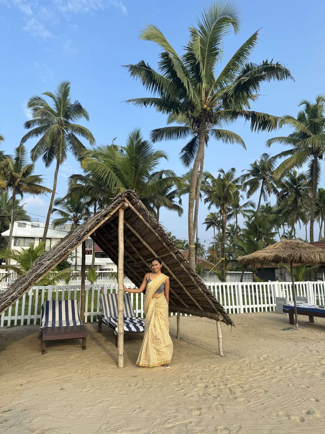 In a yellow saree under Kerala palms